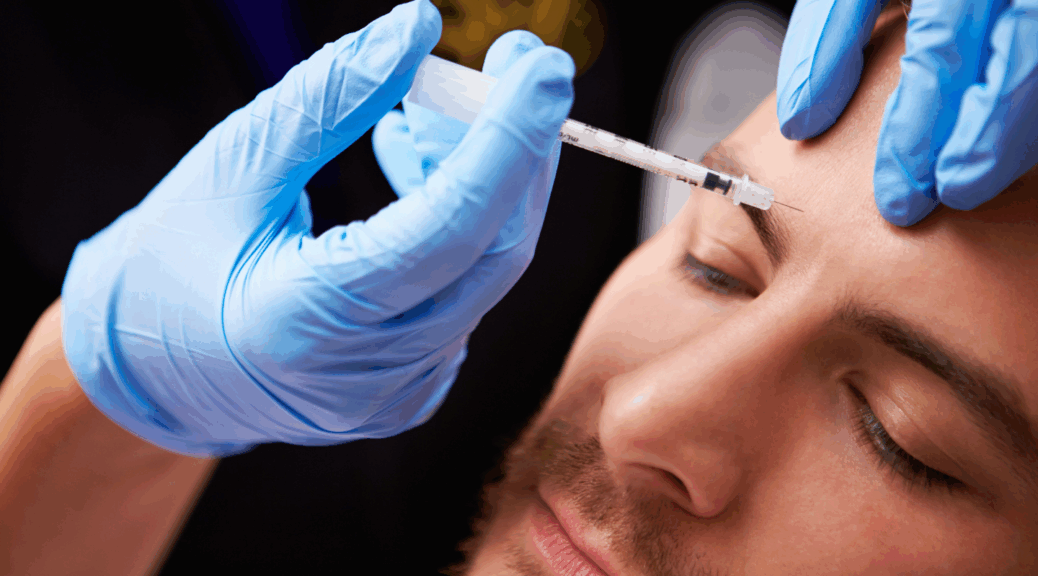 A close up of two blue-gloved hands holding a syringe of Botox at a man's forehead.